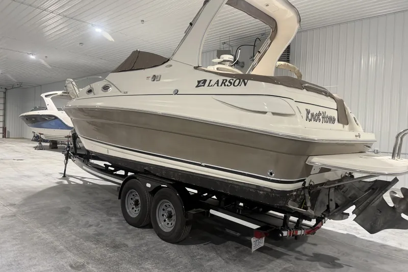 Slide: The Image of 2006 Larson Cabrio 260 boat on trailer in indoor storage facility. - 2