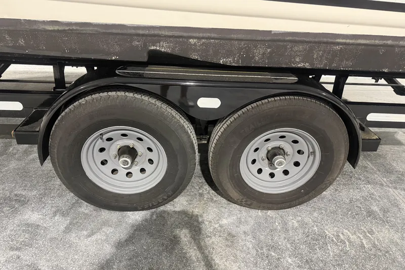 Slide: The Image of Trailer wheels of a 2006 Larson Cabrio 260 boat on a concrete surface. - 43