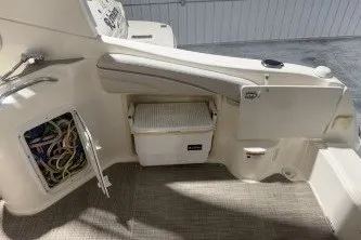 Slide: The Image of 2006 Larson Cabrio 260 boat interior with storage compartment and wiring access. - 21