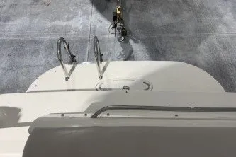 Slide: The Image of 2006 Larson Cabrio 260 boat deck with ladder and railing. - 22