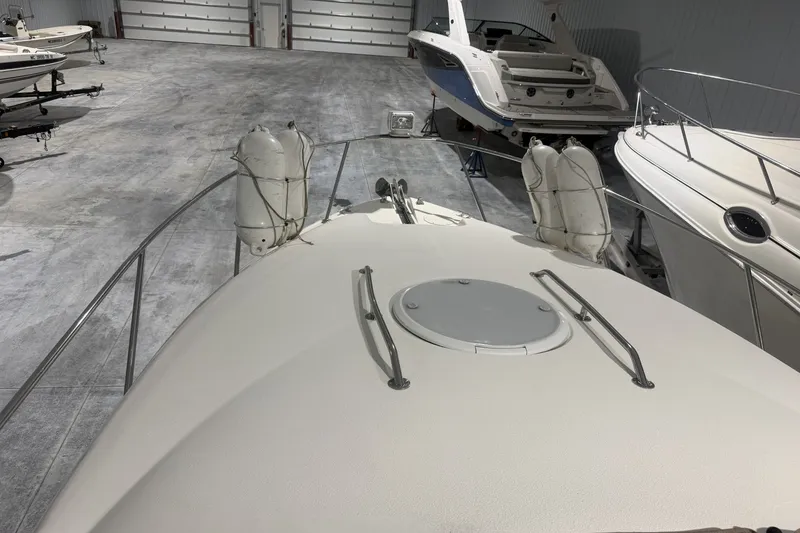 Slide: The Image of 2006 Larson Cabrio 260 boat in indoor storage, surrounded by other vessels. - 4