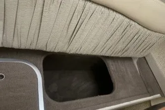 Slide: The Image of 2006 Larson Cabrio 260 interior storage compartment with beige upholstery. - 20