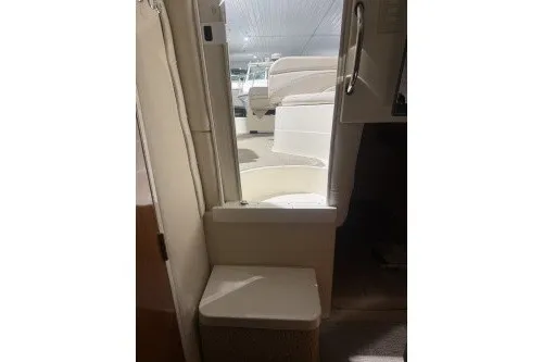 Slide: The Image of 2006 Larson Cabrio 260 boat interior with seating and cabin entry. - 23