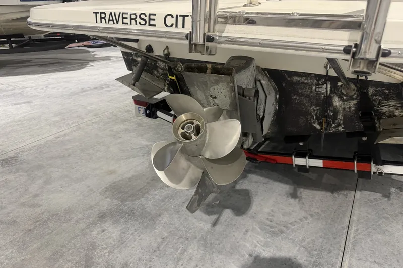 Slide: The Image of Rear view of a 2006 Larson Cabrio 260 boat with propeller, labeled "Traverse City." - 6