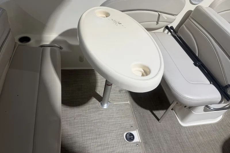 Slide: The Image of 2006 Larson Cabrio 260 boat interior with seating and oval table. - 17