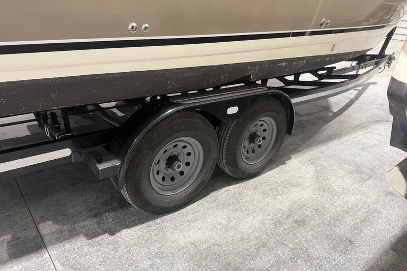 Slide: The Image of 2006 Larson Cabrio 260 boat on a dual-axle trailer in a garage. - 41