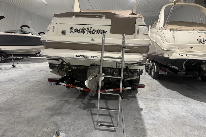 Slide: The Image of 2006 Larson Cabrio 260 boat named "Knot Home" in storage, Traverse City. - 3