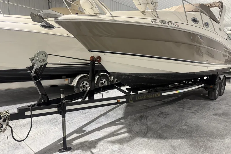Slide: The Image of 2006 Larson Cabrio 260 boat on Loadmaster trailer in indoor storage facility. - 42