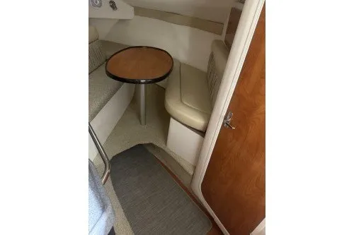 Slide: The Image of 2006 Larson Cabrio 260 cabin interior with seating and table. - 27