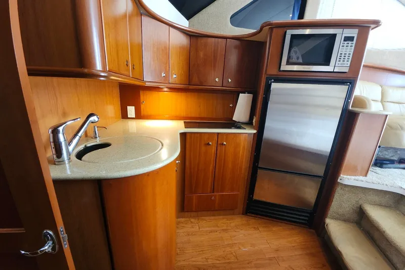 Slide: The Image of Luxurious 2008 Silverton 36 Convertible yacht kitchen with wood cabinetry and modern appliances. - 22