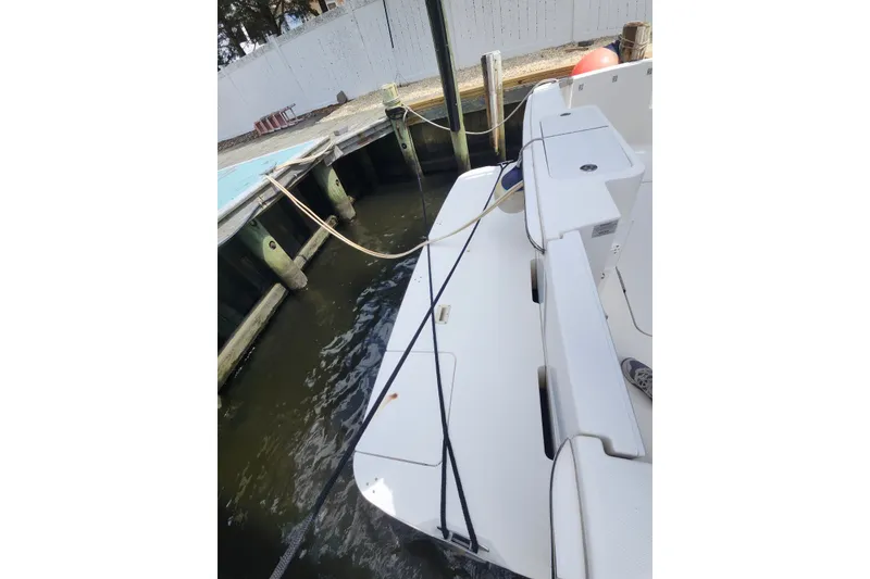 Slide: The Image of 2008 Silverton 36 Convertible yacht docked, showing rear deck and mooring lines. - 30