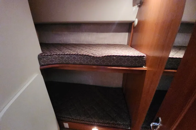 Slide: The Image of Bunk beds in 2008 Silverton 36 Convertible yacht cabin, featuring wooden finishes and cozy mattresses. - 27