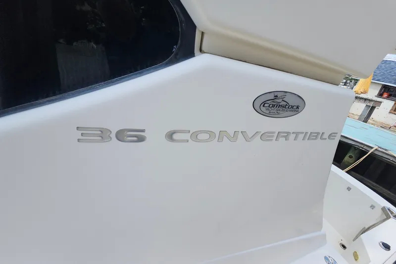 Slide: The Image of 2008 Silverton 36 Convertible yacht with Comstock Yachts logo, docked at marina. - 35