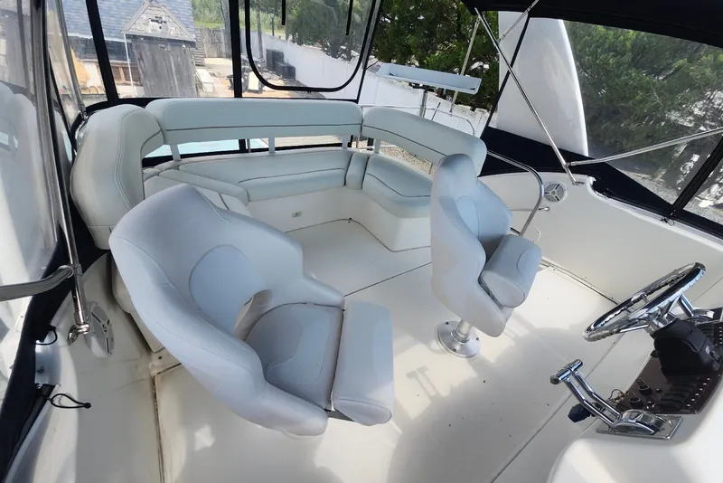 Slide: The Image of 2008 Silverton 36 Convertible yacht interior with plush seating and modern helm controls. - 14