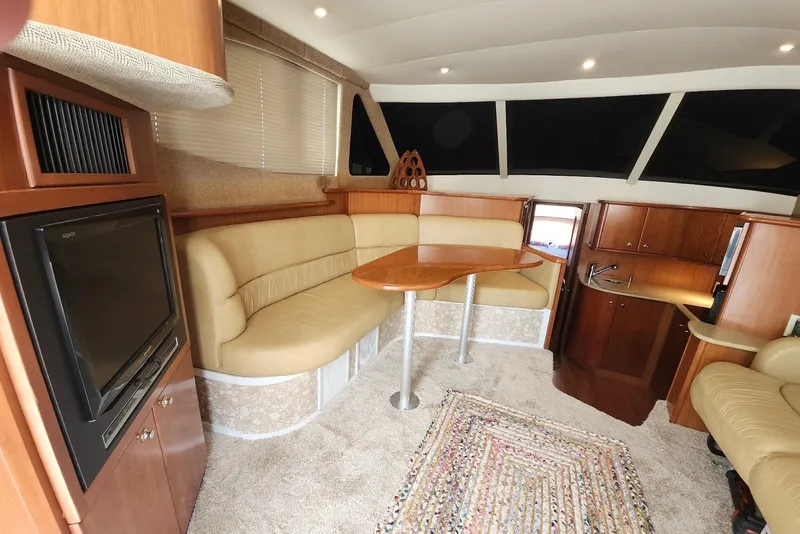 Slide: The Image of Interior of 2008 Silverton 36 Convertible yacht with cozy seating and wooden cabinetry. - 20