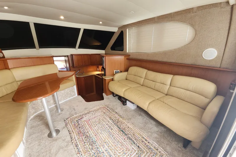 Slide: The Image of Interior of 2008 Silverton 36 Convertible yacht with beige seating and wooden accents. - 18