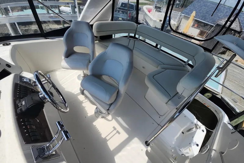 Slide: The Image of 2008 Silverton 36 Convertible boat interior with helm, seating, and steering wheel. - 15