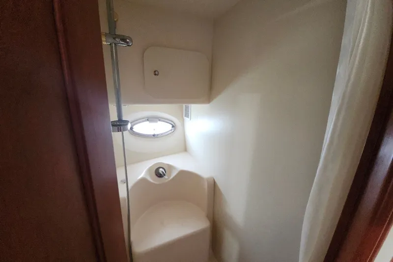 Slide: The Image of Compact bathroom in 2008 Silverton 36 Convertible yacht with porthole and shower. - 29