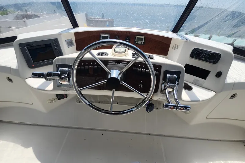 Slide: The Image of Helm of 2008 Silverton 36 Convertible yacht with steering wheel and controls. - 13