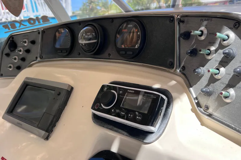 Slide: The Image of Dashboard of a 2012 Scout 210 XSF boat with gauges and controls. - 34