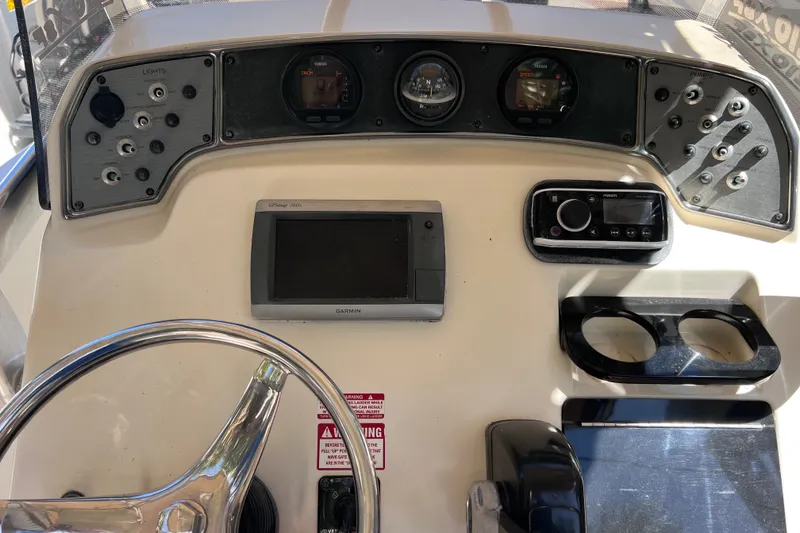 Slide: The Image of 2012 Scout 210 XSF boat dashboard with Garmin GPS and control panel. - 29