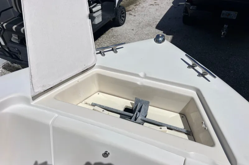 Slide: The Image of Open anchor compartment on 2012 Scout 210 XSF boat, showing storage area. - 45