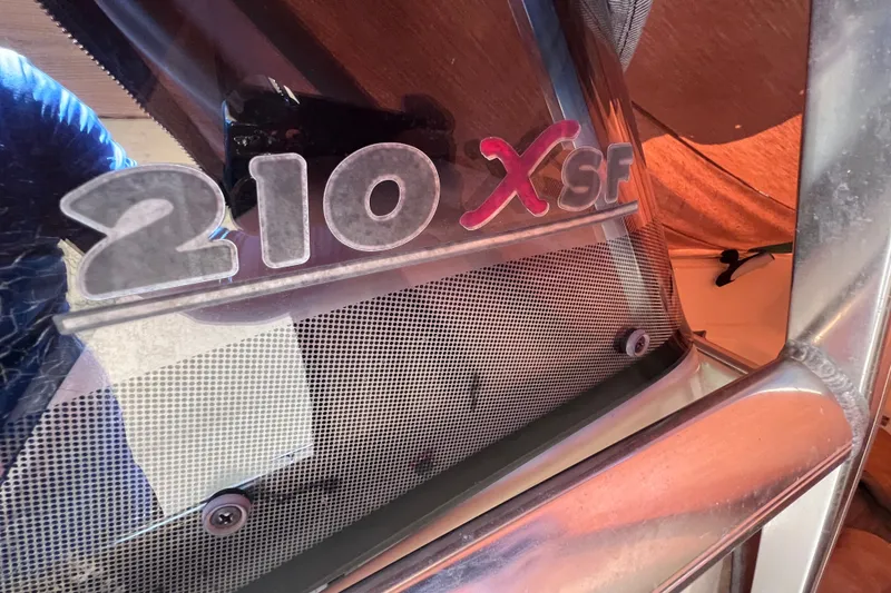 Slide: The Image of 2012 Scout 210 XSF boat logo on windshield, close-up view. - 48