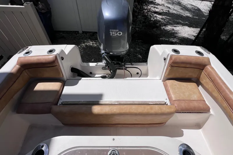 Slide: The Image of 2012 Scout 210 XSF boat interior with Yamaha 150 engine, featuring tan seating. - 15