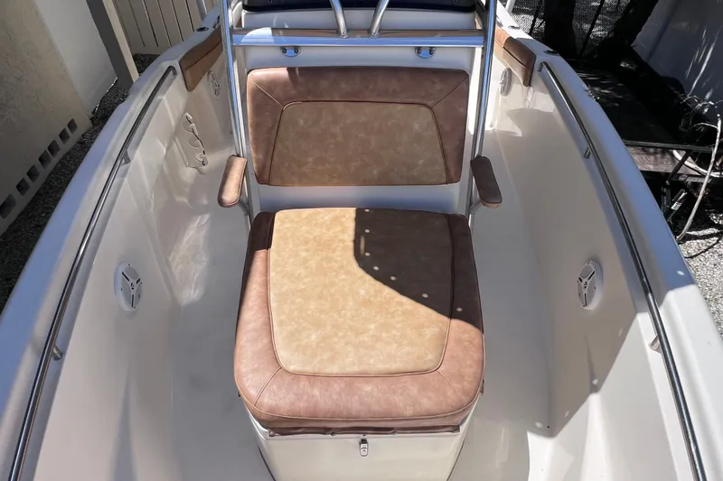 Slide: The Image of 2012 Scout 210 XSF boat interior with tan cushioned seating and stainless steel railings. - 40