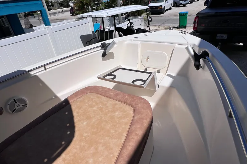 Slide: The Image of 2012 Scout 210 XSF boat interior with seating and storage compartment. - 43