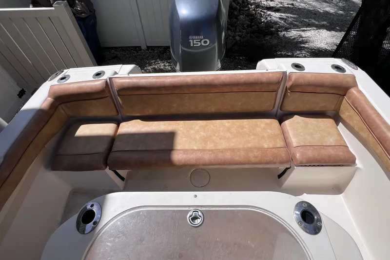 Slide: The Image of 2012 Scout 210 XSF boat with tan seating and Yamaha 150 engine. - 13