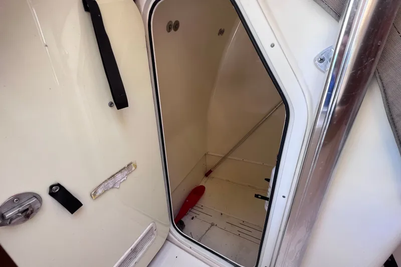 Slide: The Image of Interior view of a 2012 Scout 210 XSF boat compartment with open door. - 46