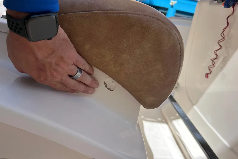Slide: The Image of Hand adjusting seat on 2012 Scout 210 XSF boat, showing upholstery detail. - 24
