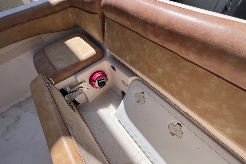 Slide: The Image of Interior of 2012 Scout 210 XSF boat with tan seating and storage compartment. - 14