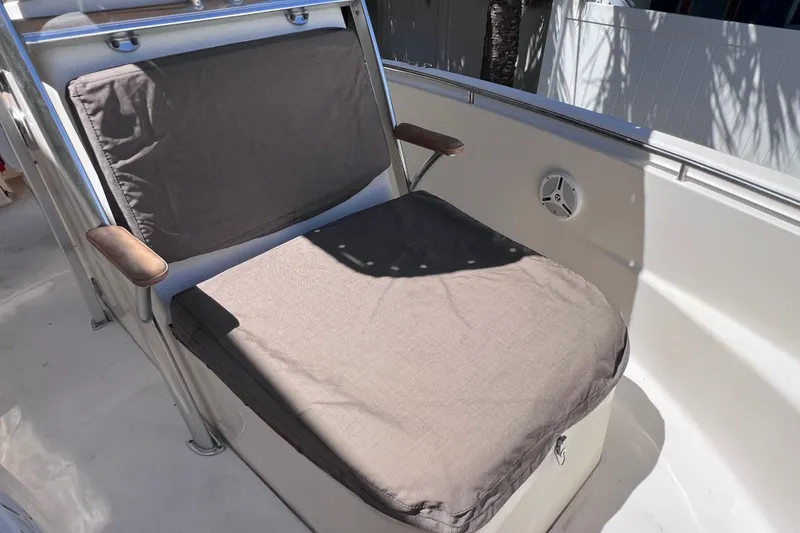 Slide: The Image of Cushioned seating on 2012 Scout 210 XSF boat, featuring armrests and speaker. - 38