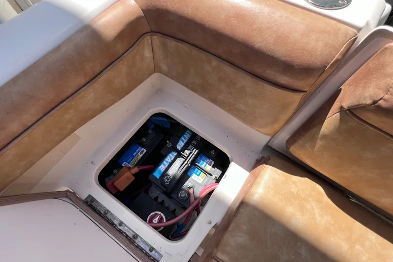 Slide: The Image of Battery compartment of a 2012 Scout 210 XSF boat with tan seating. - 19