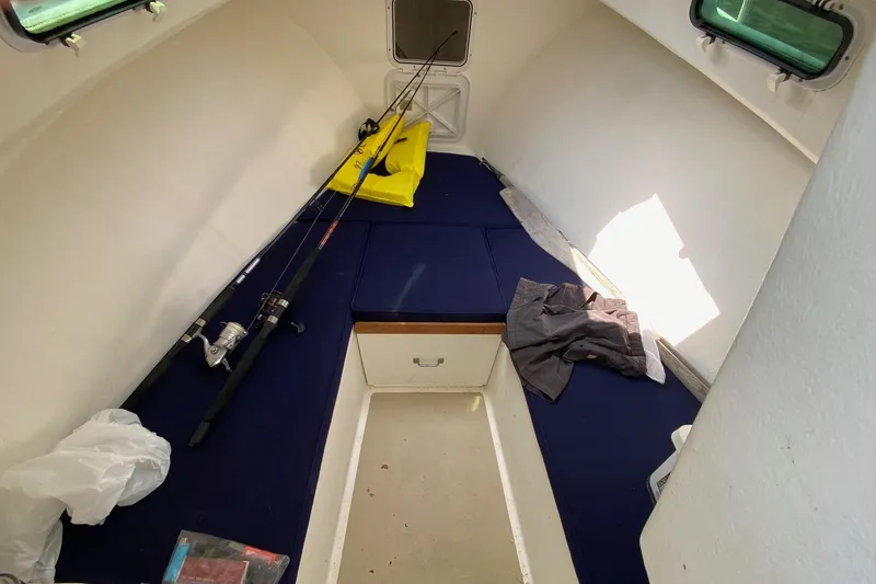 Slide: The Image of 2017 Eastern 22 Sisu Hardtop cabin interior with fishing rods and gear. - 15