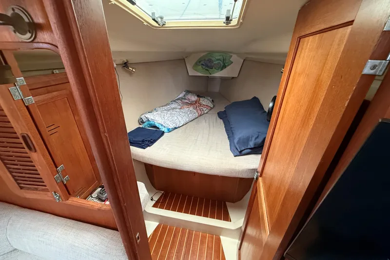 Slide: The Image of Cozy cabin interior of 1996 Hunter Legend 37.5 sailboat with wooden finishes and bedding. - 17