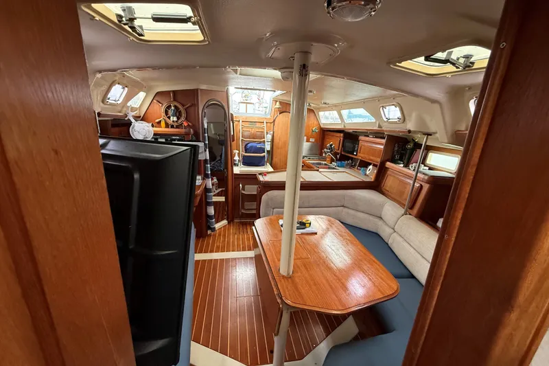 Slide: The Image of Interior of 1996 Hunter Legend 37.5 sailboat with wood finishes and cozy seating area. - 14