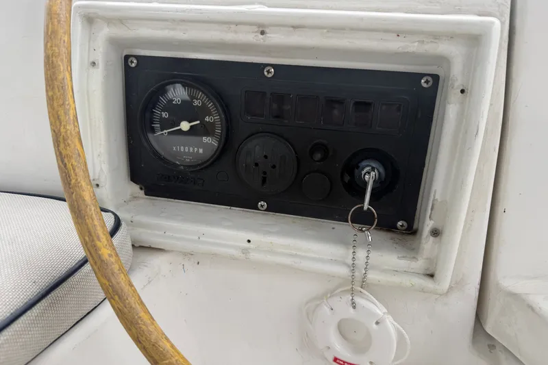 Slide: The Image of Control panel of a 1996 Hunter Legend 37.5 sailboat with RPM gauge and ignition key. - 8