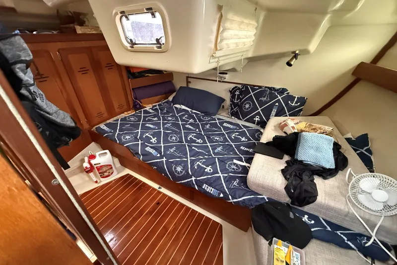 Slide: The Image of Cozy cabin interior of 1996 Hunter Legend 37.5 sailboat with nautical-themed bedding. - 20
