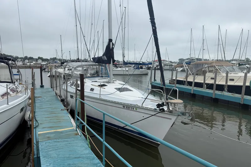 Slide: The Image of 1996 Hunter Legend 37.5 sailboat docked at marina on a cloudy day. - 4