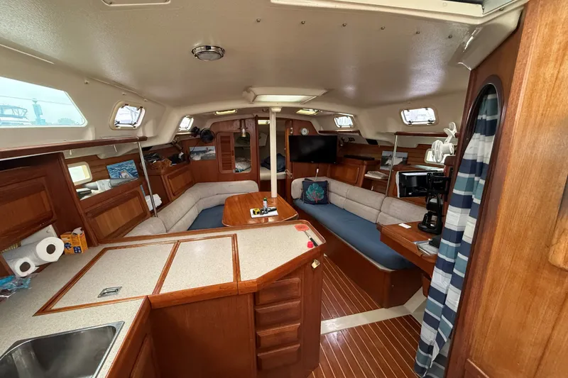 Slide: The Image of Interior of 1996 Hunter Legend 37.5 sailboat with cozy seating and wooden finishes. - 13