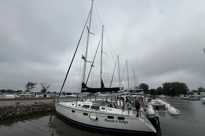 Slide: The Image of Hunter Legend 37.5 sailboat docked at marina, overcast sky, 1996 model. - 2