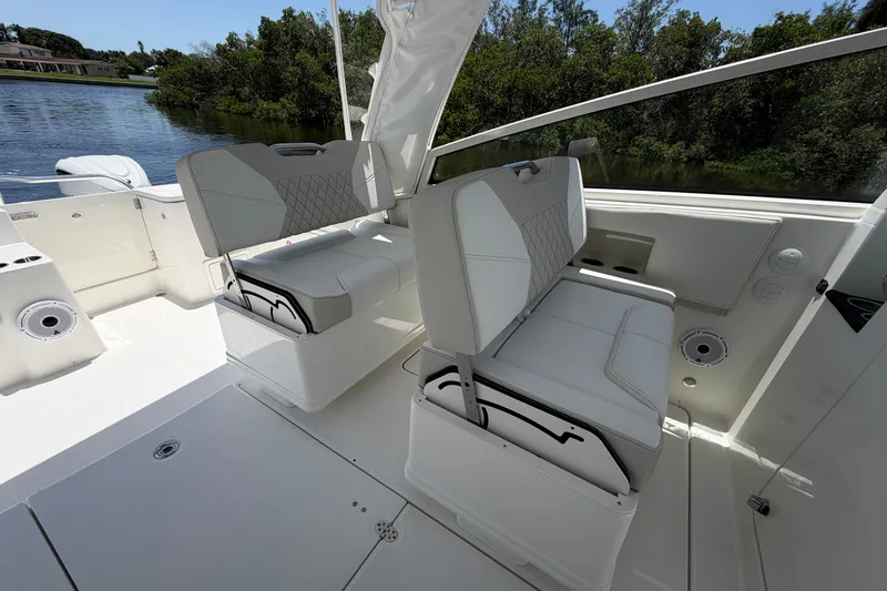 Slide: The Image of 2027 World Cat 325 DC boat interior with white seating and scenic water view. - 11