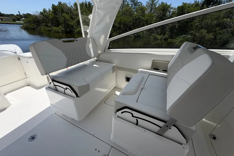 Slide: The Image of 2027 World Cat 325 DC boat interior with white seating and scenic water view. - 12