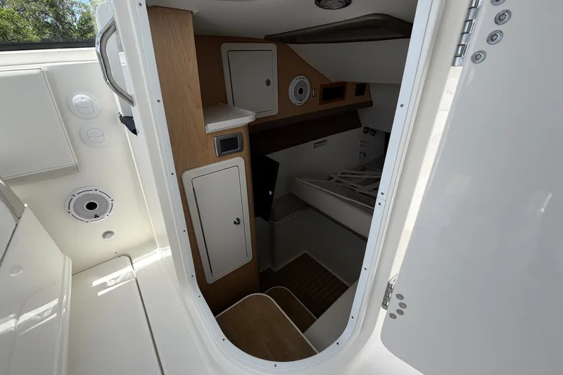 Slide: The Image of Interior cabin of 2027 World Cat 325 DC boat, featuring storage compartments and modern design. - 14