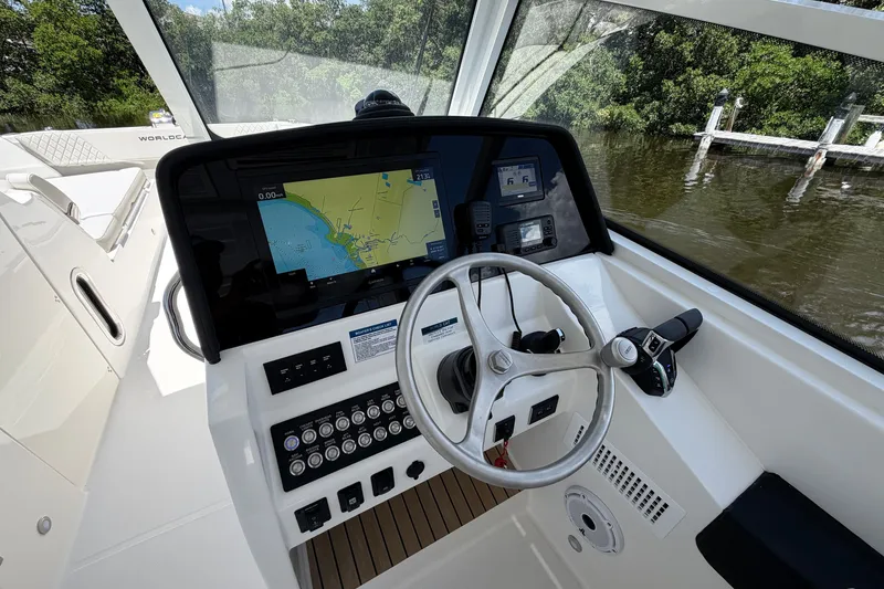 Slide: The Image of Cockpit of 2027 World Cat 325 DC boat with navigation display and controls. - 17