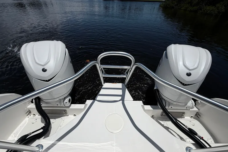 Slide: The Image of 2027 World Cat 325 DC boat with dual outboard engines on water. - 7