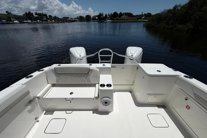 Slide: The Image of 2027 World Cat 325 DC boat deck with seating, on a calm waterway. - 8